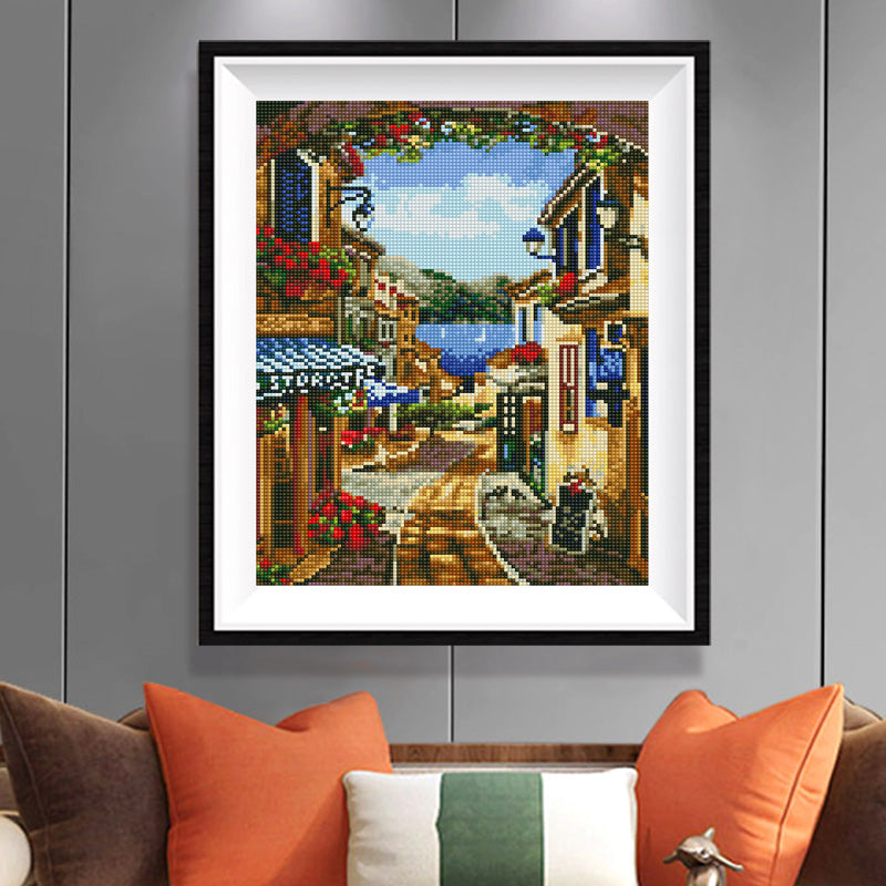 Greek Village Diamond Painting Kit – Flower Arch Framed Street with Lake View, Blue Lanterns & Bicycle JX140