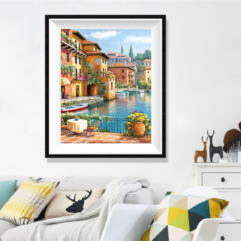 Italian Canal Café Diamond Painting Kit – Waterfront Terrace with Golden Buildings, Red Rowboat & Wisteria Reflections JX84